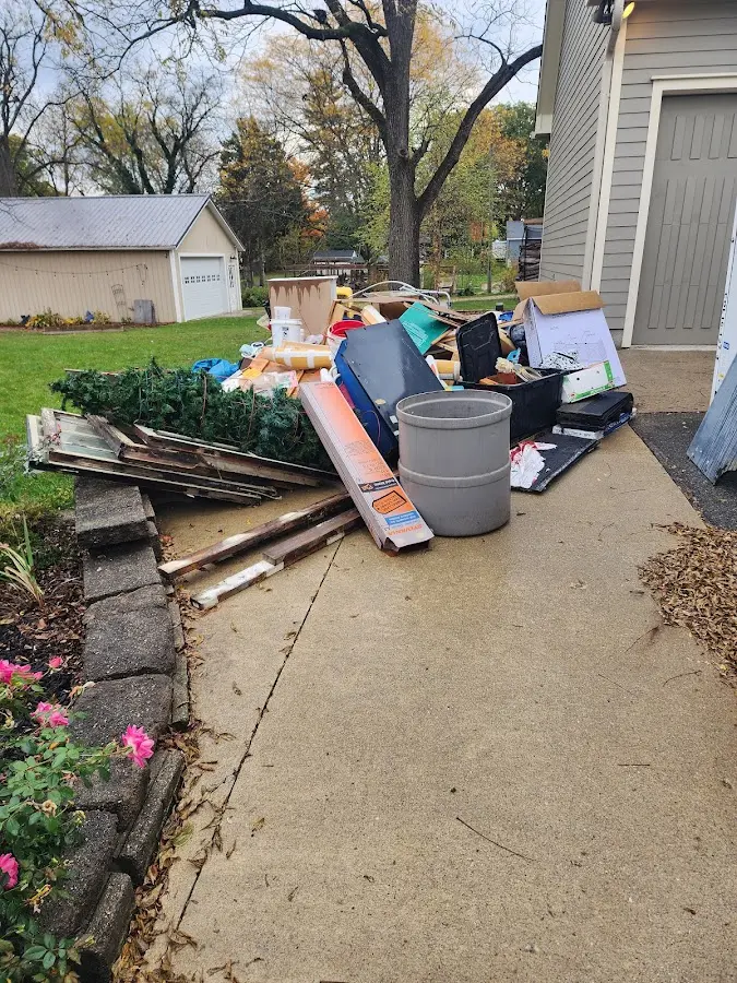 Dumpster being loaded with debris for Estate Cleanout Dumpster Rental in Mesquite